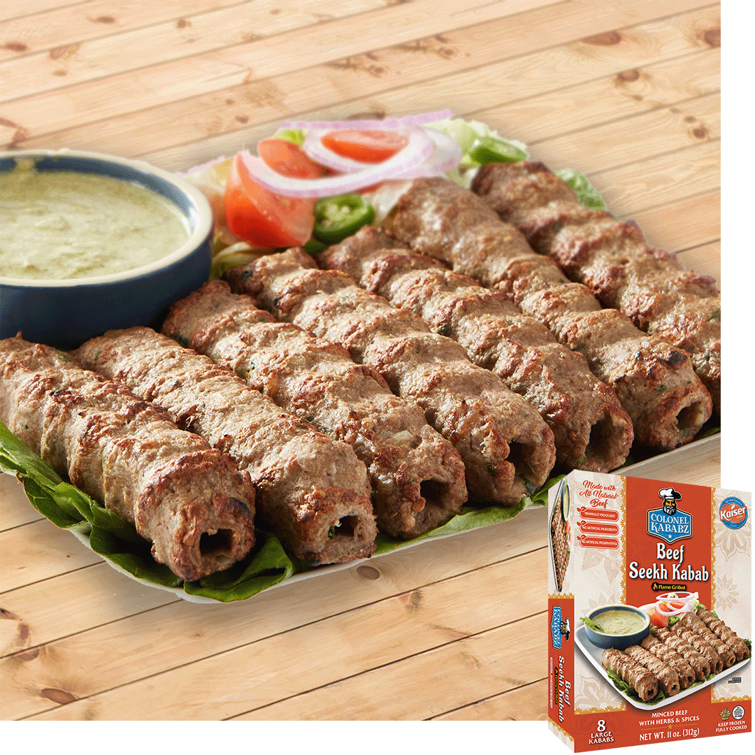 Beef seekh kabab resting on a bed of lettuce, it is garnished with onions and tomatoes, beside them is a blue bowl with a light green sauce. In the bottom right is an image of the product package