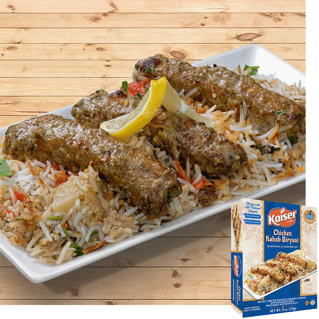Chicken kababs rest on a bed of biryani rice, they are garnished with a strip of lemon. In the bottom right hand corner is an image of the product package