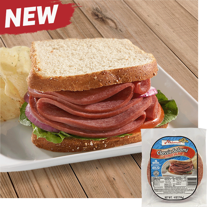 A Halal Beef salami sandwich with white bread red onion, tomato, and lettuce on a white plate with some potato chips behind to the left. A pack of Midamar Halal Classic Salami is overlayed in the bottom right corner.