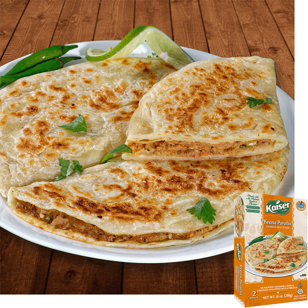2 Keema paratha are on a plate half of one is stiting one top. Inside the paratha is a ground lamb and hcicken mix with small pieces of vegetables. There are a few pieces of cilantro spread around them. A box of Kaiser Keema Paratha is in the bottom right corner.