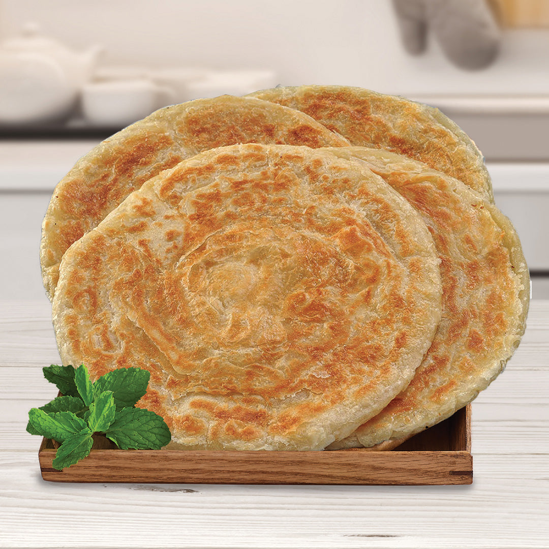 4 paratha are resting in a small wooden tray. There is a garnish of a green leaves in the box